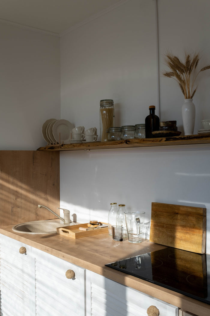 Eva Solo minimalist kitchenware on a sunlit wooden shelf